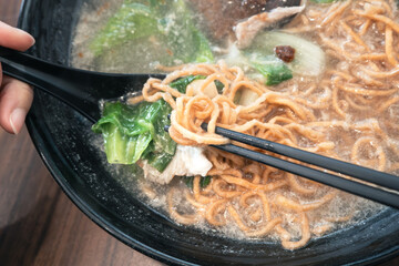 Taiwanese pot style noodles, nabeyaki yi mein with egg and vegetables.