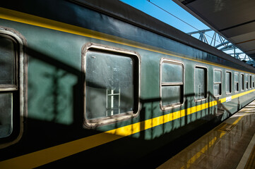 The green train, China Railway, is parked at the platform