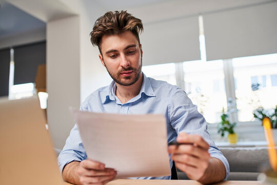 Young businessman calculating business expenses working  from office