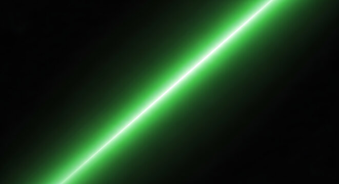 A vibrant, bright green laser beam cuts diagonally across a dark black background, creating a sharp striking light effect.