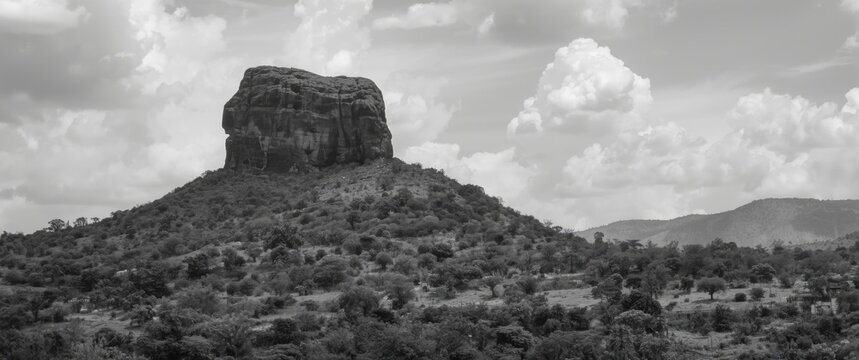Black and white depiction of Zuma Rock, a prominent monolith and igneous intrusion of gabbro and granodiorite in Niger State, Nigeria, close to Abuja