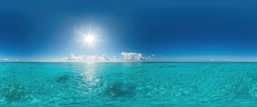 Ocean under a blue sky with the sun