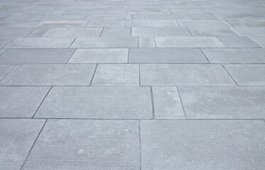 New paving made with stone blocks of rectangular shape in a pedestrian zone - Sandstone with a scratched surface