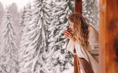 Naklejka premium Woman Enjoying Hot Drink in Winter Landscape