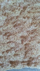 Macro Texture of Ground Cinnamon and White Sugar on Raw Pastry Dough