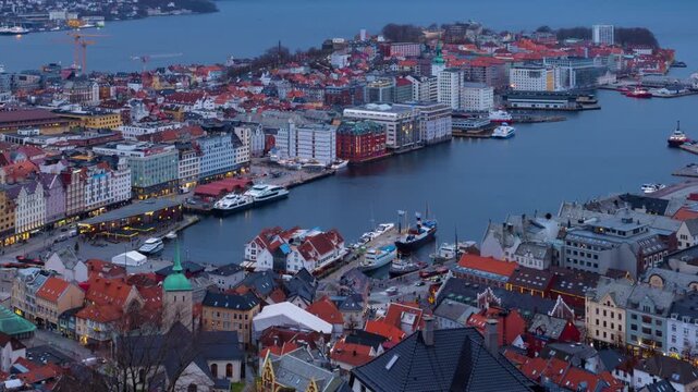 Bergen, Norway. Aerial view of Bergen, Norway at night. Cloudy sunset sky over the city with illuminated roads and car traffic. Time-lapse of Bryggen