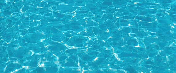 Fototapeta premium Ripple wave background on blue swimming pool water surface, summer abstract reflection