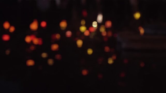 The lantern's reflection blurred into patches of light on the rippling water.