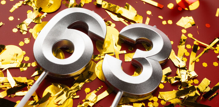 Number 63 celebration birthday digit on Red festive with confetti background. sixty-three year birthday. concept of birthday, anniversary and date.