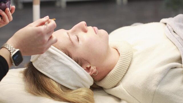 Johvi, Estonia &ndash; December 24, 2026: A woman undergoes an IPL facial cosmetic procedure using light-based aesthetic equipment in a beauty clinic. Real clinical environment during a professional cosmeto