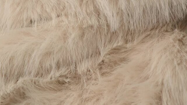 Detailed close up of luxurious soft light brown shaggy faux fur texture pattern background material