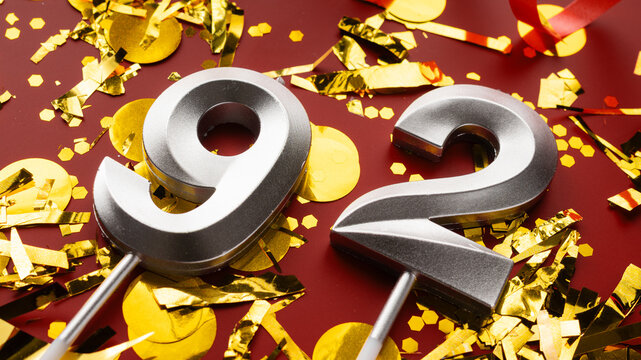 Number 92 celebration birthday digit on Red festive with confetti background. ninety-two year birthday. concept of birthday, anniversary and date.