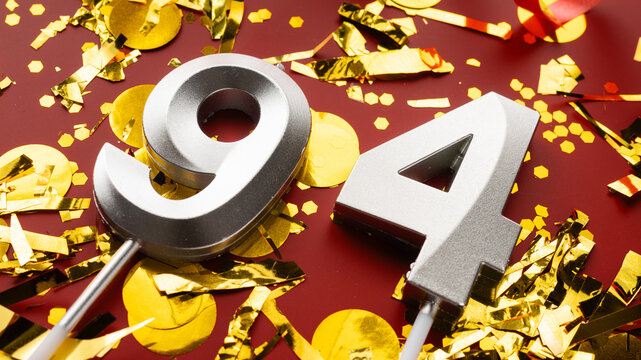 Number 94 celebration birthday digit on Red festive with confetti background. ninety-four year birthday. concept of birthday, anniversary and date.