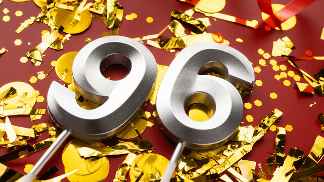 Number 96 celebration birthday digit on Red festive with confetti background. ninety-six year birthday. concept of birthday, anniversary and date.