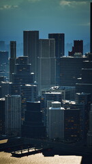 Fototapeta premium Dense waterfront highrises rising above harbor in hazy midday light, layered towers and industrial piers create textured skyline, reflective glass and concrete