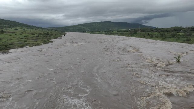 Cinematic low-level drone footage flying along a flooded river in southern Kruger National Park.