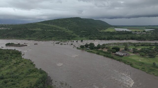 Smooth, cinematic drone footage performing a slow rotation over the confluence of flooding rivers in southern Kruger National Park, near Komatipoort.