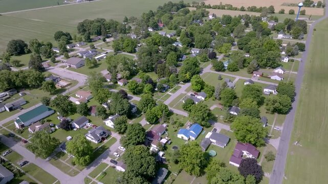 Neighborhood homes in Perrington, Michigan with drone video moving in.