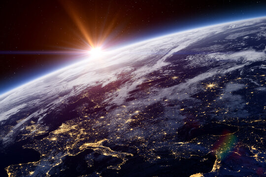 Earth. Sunset over planet Earth. Europe at night view from space. Earth planet with a blue atmosphere and space background. Space high resolution background.