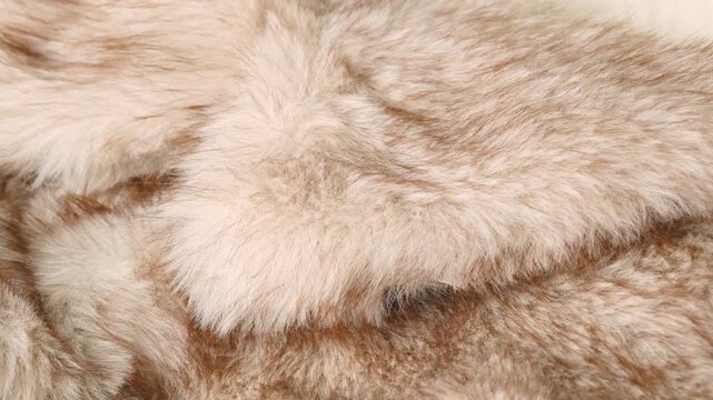 Abstract pattern of soft warm cozy light brown fluffy faux fur blanket material closeup