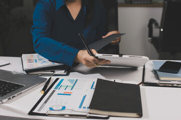 Fototapeta premium Businesswomen analyzing financial data, discussing investment strategy in office