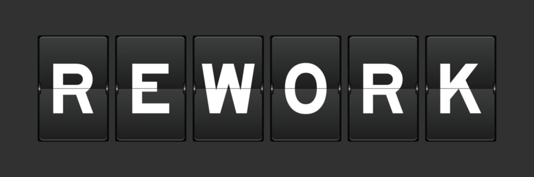 Black color analog flip board with word rework on gray background