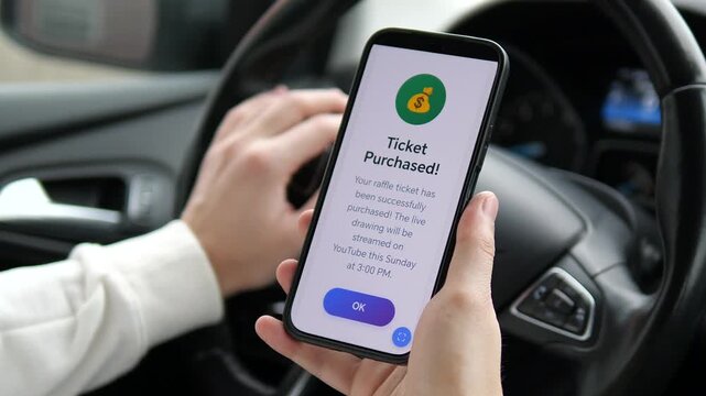 Hands holding phone with online raffle ticket confirmation in vehicle. Modern digital lifestyle: purchasing lottery tickets on the go. Clean interface, vivid colors. Ideal for fintech marketing