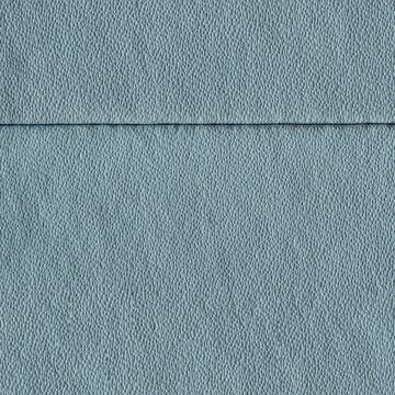 Light blue textured wall surface with subtle horizontal seam