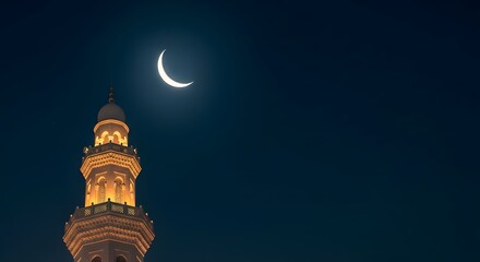 Crescent moon shines above illuminated minaret at night