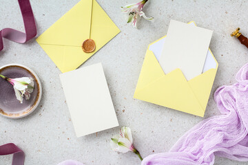 Elegant wedding stationery with yellow envelopes and vertical blank card for design.