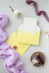 Wedding stationery set. Creative vertical mockup with yellow envelopes and vintage wax seal stamp tool.