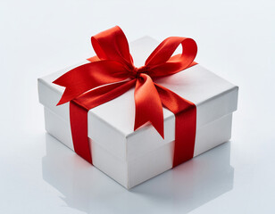 Obraz premium White Gift Box with Red Ribbon Bow Isolated on White Background Holiday Present Packaging Celebration Concept
