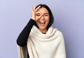 Woman making an ok sign over her eye with a scarf