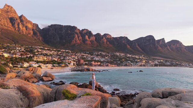 Sunset Over Camps Bay Beach in Cape Town, South Africa, Featuring Table Mountain and Coastal Rock Formations