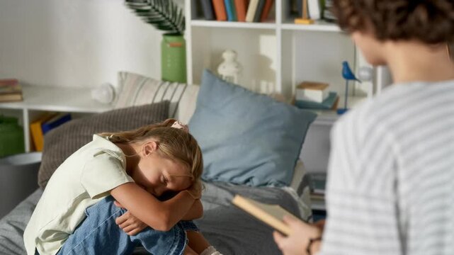 Upset young girl crying covering face with hands while arguing with parent in bedroom, AI generated video