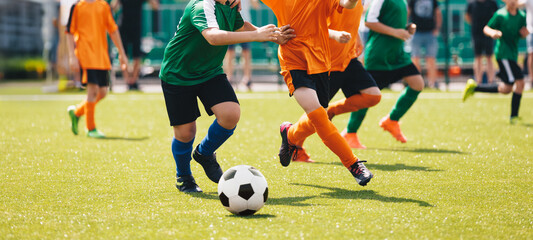 Youth Soccer Match Action Near Goal  Kids Competing for Football Ball During Outdoor Game © matimix