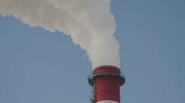 Air pollution. Smoking chimney of a coal power plant. Closeup shot.