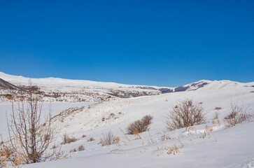 scenic view of Kechut Reservoir and snow covered mountains around Jermuk (Vayots Dzor, Armenia)