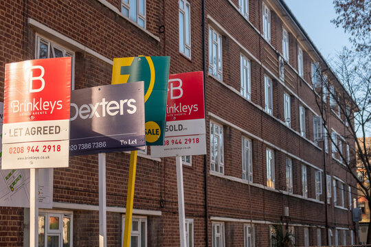LONDON - SOUTH WEST LONDON RESIDENTIAL STREET &ndash; Cluster of estate agent boards with sold STC and let agreed signs outside Victorian