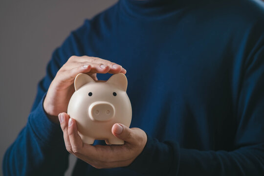 Hands protecting a piggy bank, representing financial security, saving money, wealth protection, personal finance planning, risk management, and long term financial stability concept.