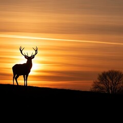 Naklejka premium Majestic Deer Silhouette at Sunset on Hill with Tree and Dramatic Sky