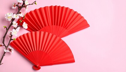 Red Paper Fans and Blossoms on Pink Background Symbolizing Elegance and Editorial Styling for Cultural and Seasonal Themes