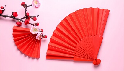 Red Paper Fans and Blossoms on Pink Background Symbolizing Elegance and Editorial Styling for Cultural and Seasonal Themes