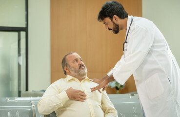 Fototapeta premium A concerned doctor is talking to his patient about his chest pain.