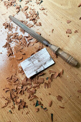 Woodworking tools and shavings on a wooden surface