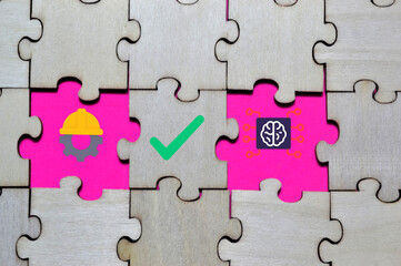Obraz premium Wooden puzzle with missing pieces revealing gear, check mark, and AI brain icons on pink background symbolizing collaboration between engineering, accuracy, and intelligent systems for editorial 