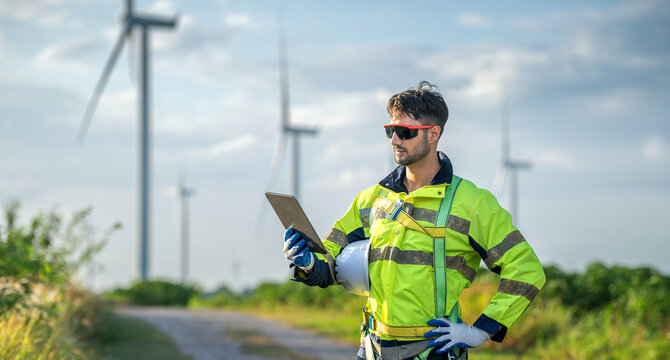 Male man engineer inspection by tablet gesture check control wind power machine out door wind energy factory. technician professional worker check wind power machine turbine field inspection