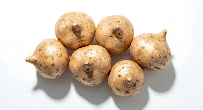 A cluster of oca tubers displayed on a plain white surface top view