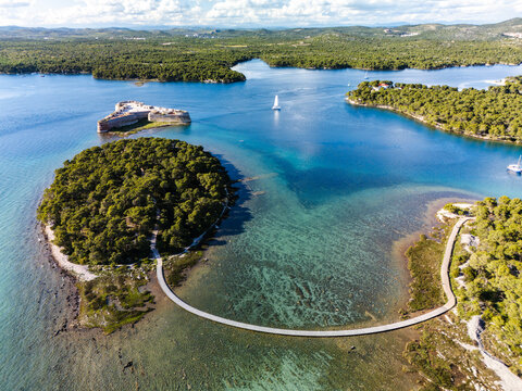 Aerial view of the historic St Nicholas' Fortress standing guard amidst the shimmering Adriatic, surrounded by lush islands, Sibenik, Croatia.