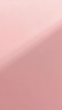 Vertical video: Shifting camera nudging blurred pink surface close-up, exposing fingertip near lens